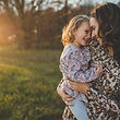 mom with child together smiling.