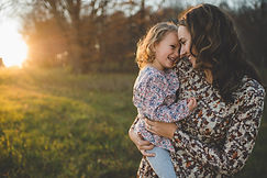 mom carrying daughter