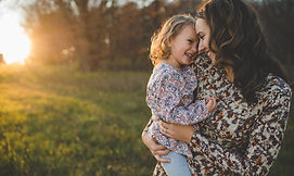 mom carrying daughter