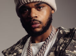 K-Trap wearing a light beanie and patterned jacket