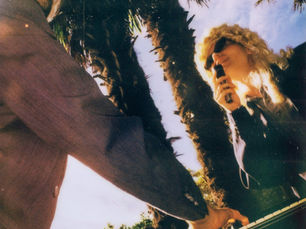strongboi duo outdoors with keyboard beneath palm trees