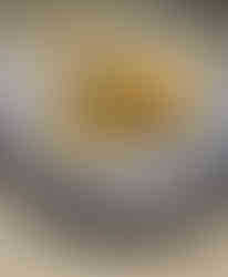 Mango cheesecake topped with whipped cream on a plate