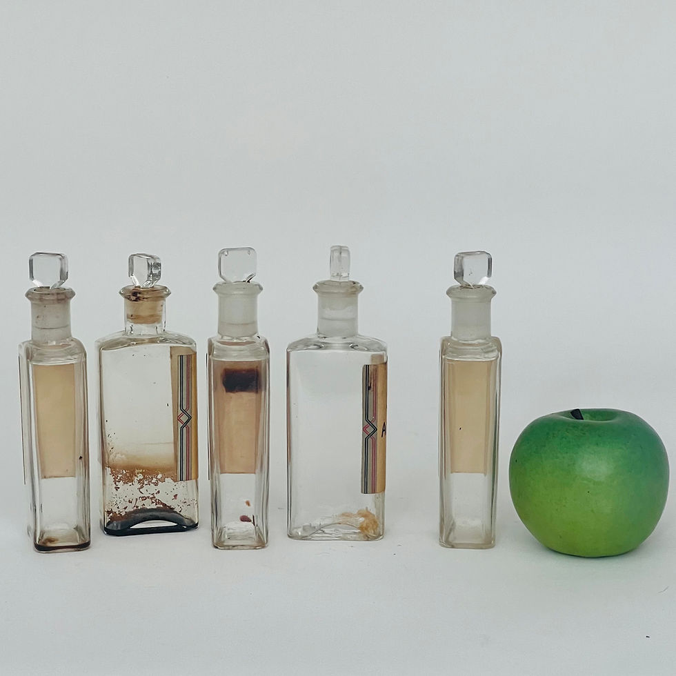 Thumbnail: A set of five clear, square glass medicine bottles.