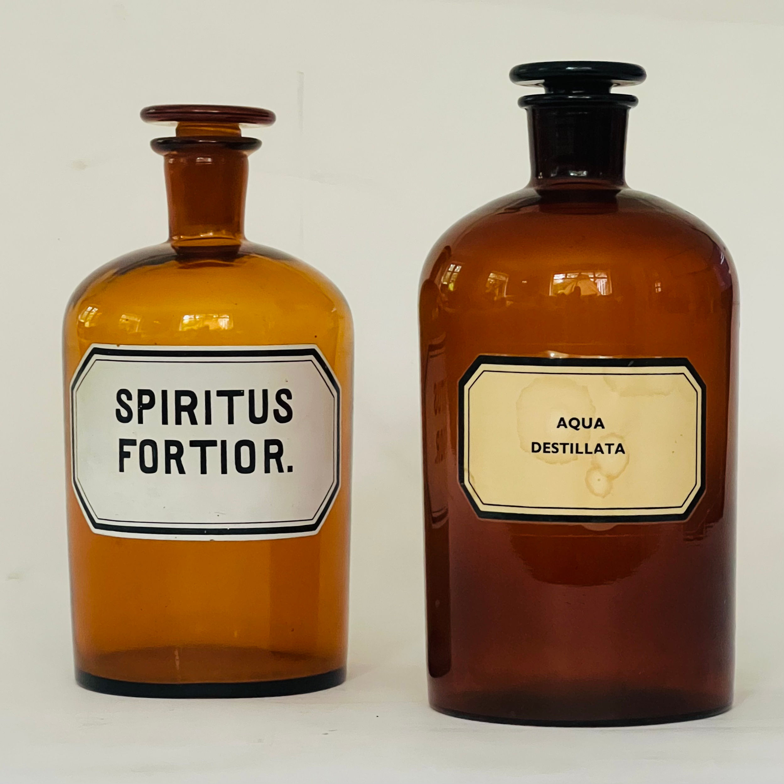 Two vintage amber apothecary bottles.