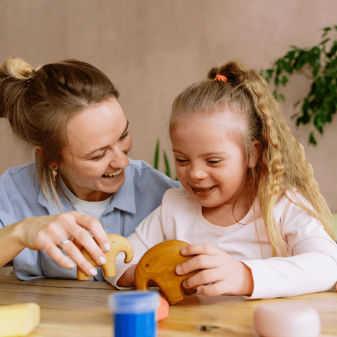 Mother and young daughter with Down syndrome playing together, reflecting Florida special needs trust and trustee planning