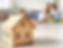 Wooden house model in front of a family at home, representing estate planning, asset protection, and legacy planning.