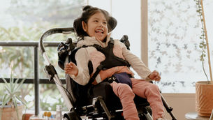 Smiling child with special needs in a wheelchair, symbolizing how Florida families can protect SSI and Medicaid benefits through proper resource transfer planning and special needs trusts.