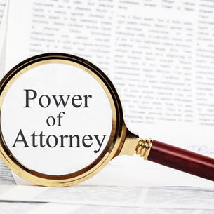 Magnifying glass held over a Florida power of attorney document, highlighting the words Power of Attorney