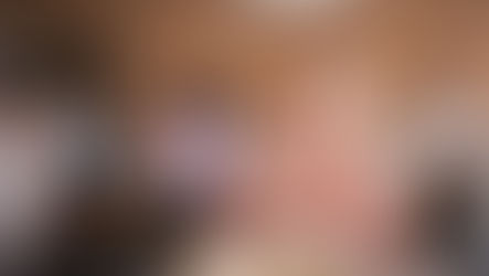 A young woman with Down syndrome wearing a pink sweater smiles and claps in a classroom, surrounded by other students — Legacy Solutions Law Firm.