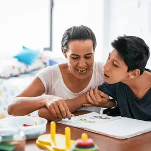 Mother helping her disabled adult child with activities at home in Florida, illustrating the importance of SSI and special needs planning when a parent retires