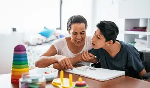 Mother helping her disabled adult child with activities at home in Florida, illustrating the importance of SSI and special needs planning when a parent retires