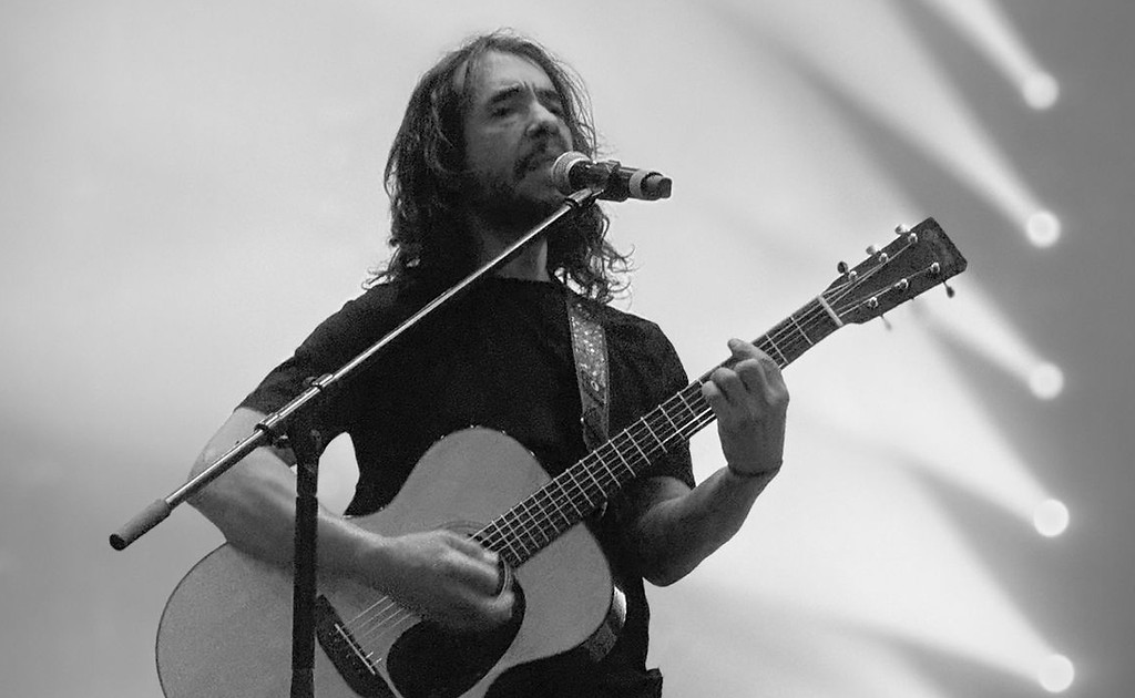 Live guitar and singing performance during concert setup