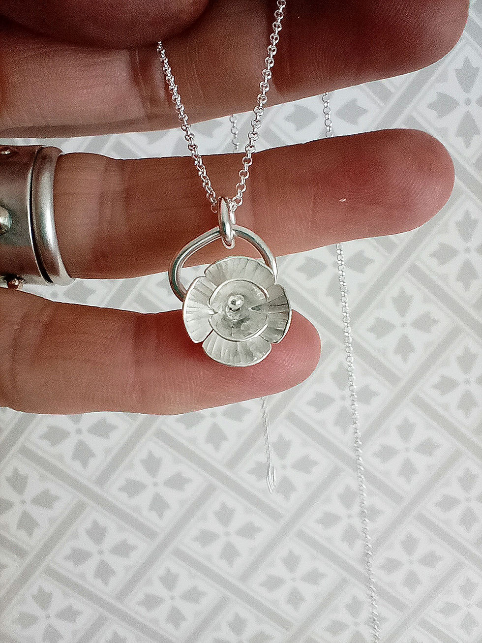 Silver dancing flower pendant