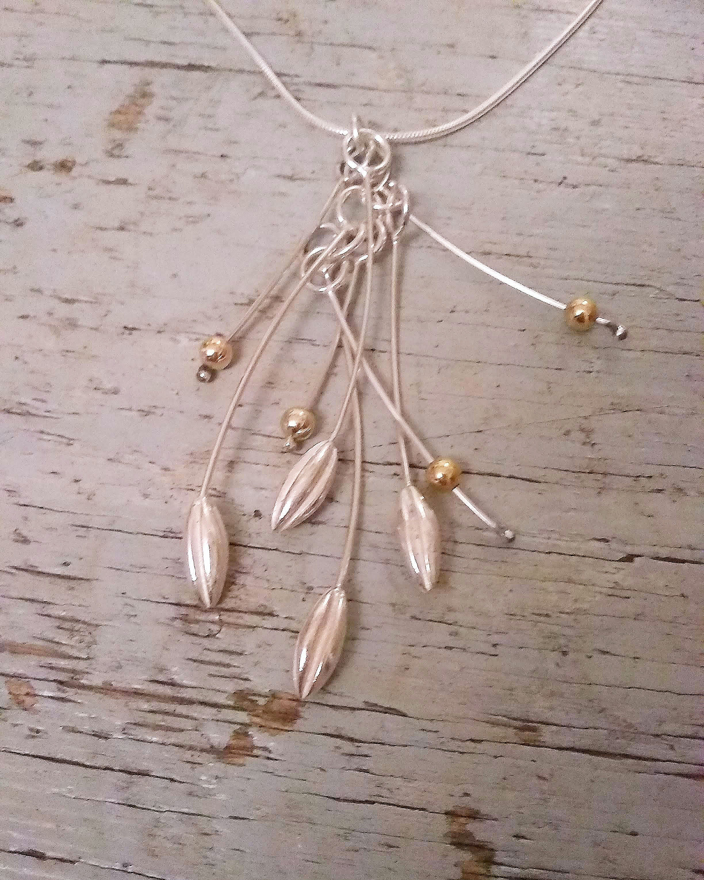 Silver cascade seed pod necklace with gold elements