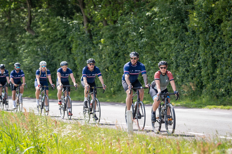 Team of cyclists following a Red Fox Cycling Guide on a country road