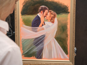 A beautiful live wedding painting displayed on an easel during the ceremony. Elena Valerie, 2025