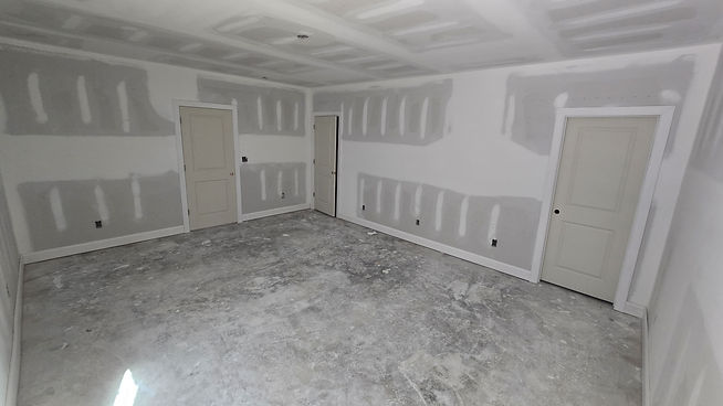 Interior doors and trim being installed as part of a custom home renovation, marking the finish carpentry phase before painting and final interior finishes.