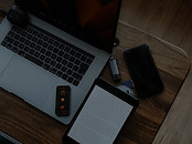 Laptop, tablet, and phone on a wooden de