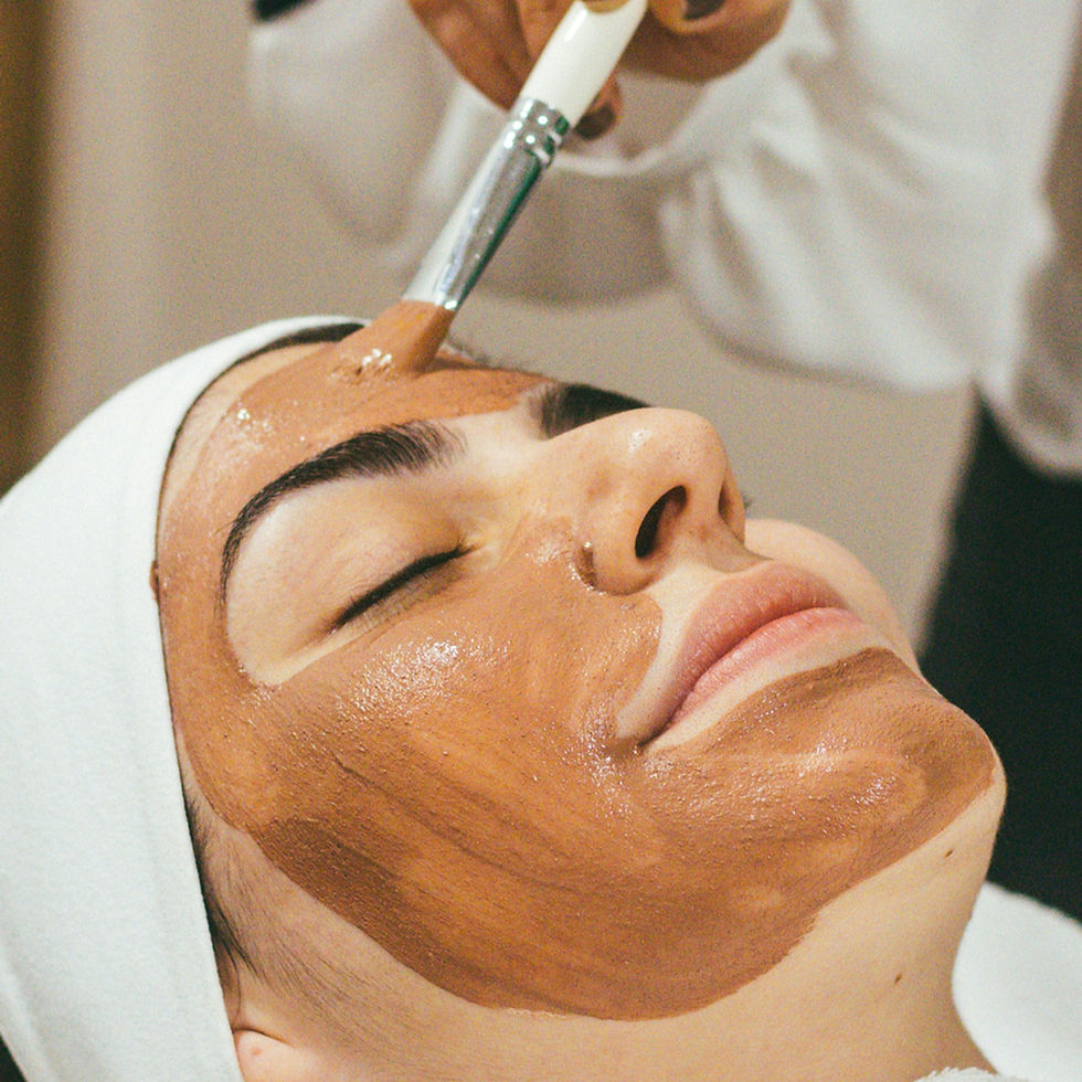 High angle view of facial treatment setup with skincare tools and products