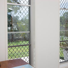 Double hung windows with Prowler Proof Diamond welded aluminium grille security screen installed.