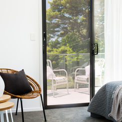 Prowler Proof Protec perforated aluminium security screens installed on sliding door in bedroom.