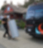 Jamie pushing a hot water tank next to the Trident Plumbing and Heating van