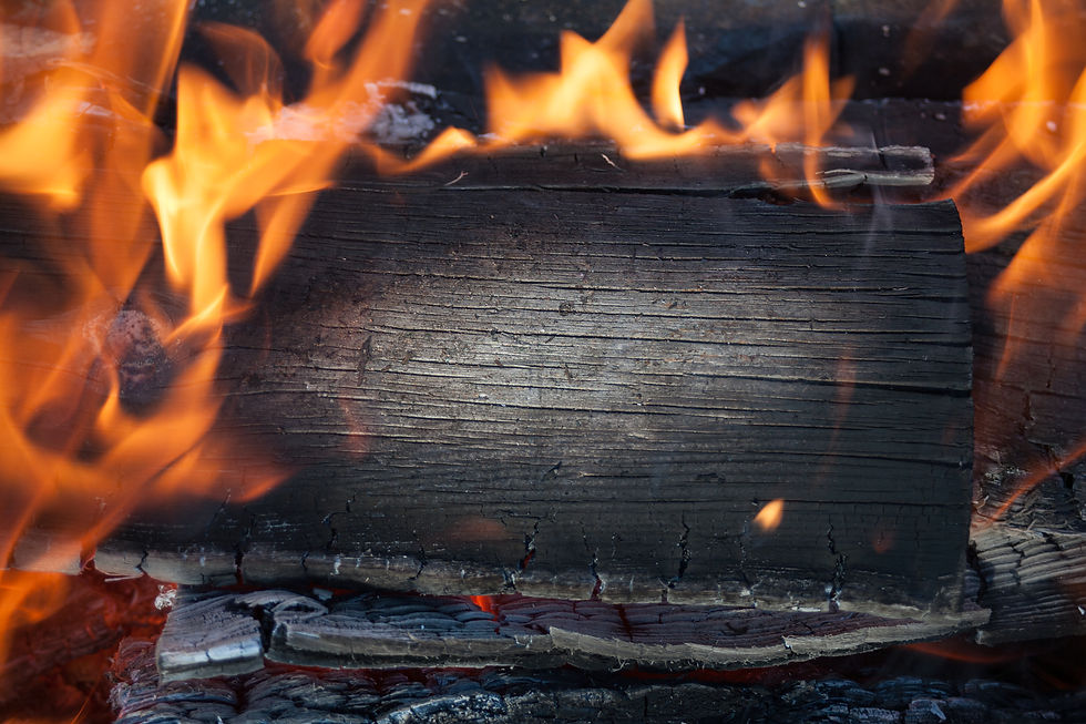 Burning black horizontal board with open red fire flame. Dark grey burned wooden board tex