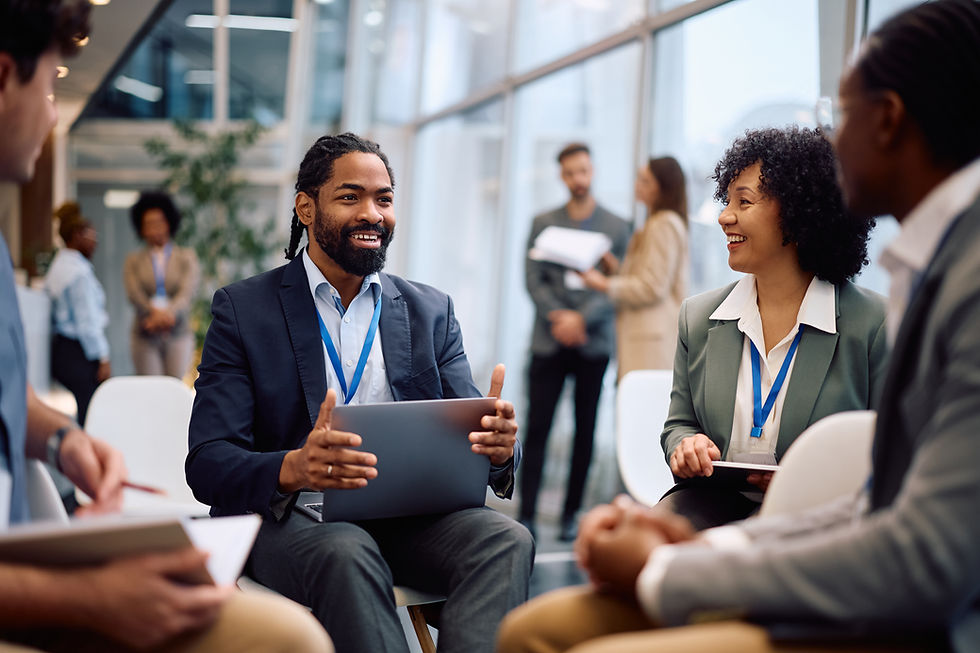 Group of coworkers chat at workplace performance workshop.