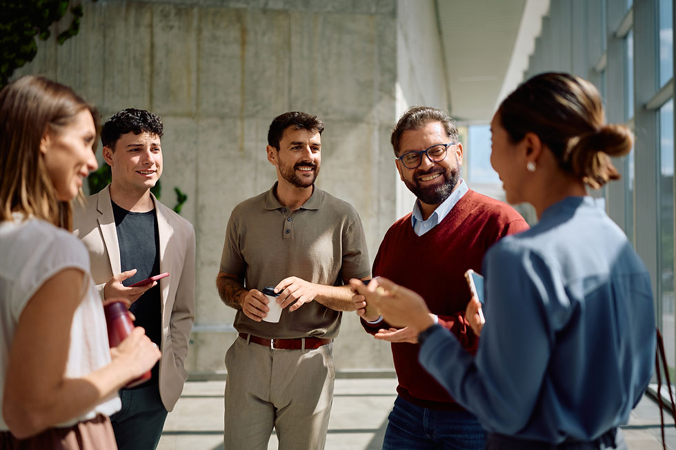 Group of multiracial coworkers gather in office lobby.