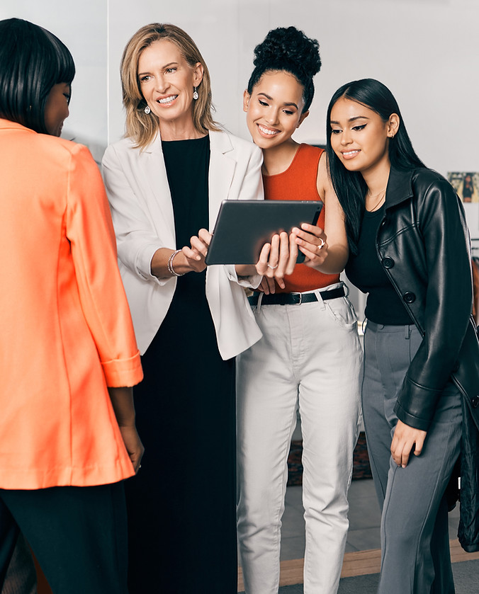 group of women looking at a tablet
