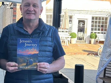 Brock Alston holding a copy of Jetson’s Journey under the Middle Tennessee Authors Circle tent, space 206, at PumpkinFest on Main Street in Franklin, October 25, 2026.