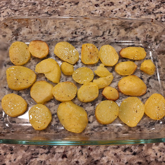 In a large baking dish, layer half of the roasted potatoes on the bottom. - Add a layer of half the roasted eggplant slices. - Spread half of the meat sauce over the eggplant layer. - Repeat the layers with the remaining potatoes, eggplant, and meat sauce. - Pour the creamy topping evenly over the top, spreading it with a spatula to cover the entire surface.