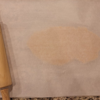 Place the dough between two sheets of parchment paper. Roll it out as thinly as possible, about 1/8 inch (3mm).