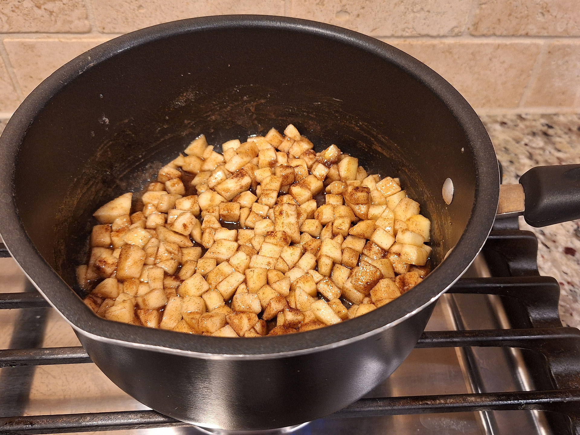 Heat butter in a skillet over medium heat. Add apples, sugar, and cinnamon. Cook until softened and slightly caramelized, about 5-7 minutes. Let cool.