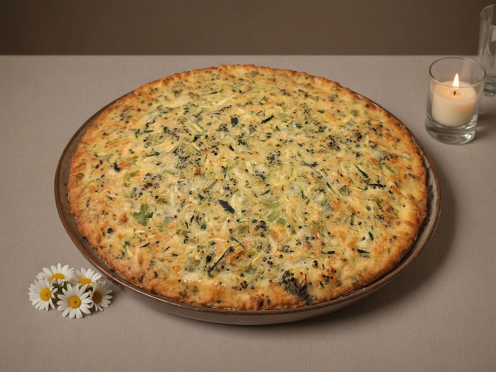 A vegetable pie on a brown plate, set on a gray table with daisies and a lit candle. The mood is cozy and inviting.