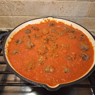 Gently place the browned meatballs into the sauce. Simmer uncovered on low for 25–30 minutes, turning them halfway through. Stir in 1 tablespoon of butter before serving for extra richness. Optional: add 1 tablespoon Parmesan.
