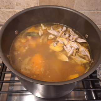 Remove the chicken drumsticks from the pot. Let them cool slightly, then remove the skin and bones. Shred the meat and return it to the soup.