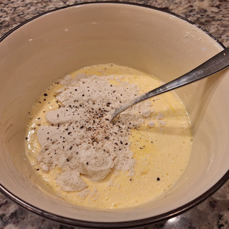 Grease a 9-inch round baking dish. Pour in the mixture and level it out. Optional: Dust top lightly with flour or breadcrumbs for a golden finish. Bake at 170°C (340°F) for 60–75 minutes, until golden and set in the center. Tent with foil if browning too quickly.