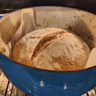 Preheat oven to 475°F (245°C) with a Dutch oven inside for at least 30 minutes. Turn the dough out onto parchment, score with a sharp blade or lame, and carefully place into the preheated Dutch oven. Bake covered for 20 minutes Then uncover, reduce temperature to 450°F (230°C), and bake another 20–25 minutes until deeply golden and internal temperature reaches ~205°F (96°C).