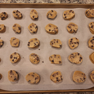 Cut the chilled dough into ½-inch thick rounds, place them on the baking sheet, and bake for 10-12 minutes until edges are golden but centers remain slightly soft.