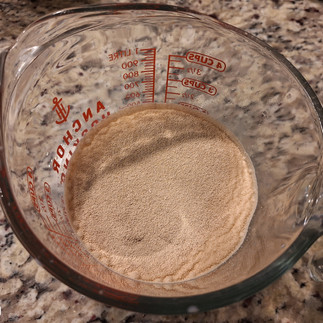 In a large bowl, combine warm milk, warm water, and sugar. If using active dry yeast, sprinkle it over and let it sit until foamy (about 5–10 minutes). If using instant yeast, you can skip the bloom.