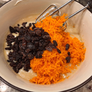 Fold in grated carrots and raisins.