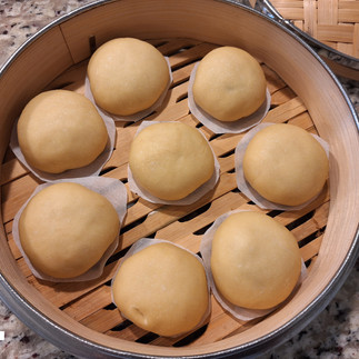 Bring water to a boil in a wok or wide pot. Place the bamboo steamer on top (with lid), making sure the water doesn’t touch the buns. Steam buns for 12–13 minutes. Turn off heat, let them sit covered for 3 minutes before opening the lid. Serve warm for the best gooey center.