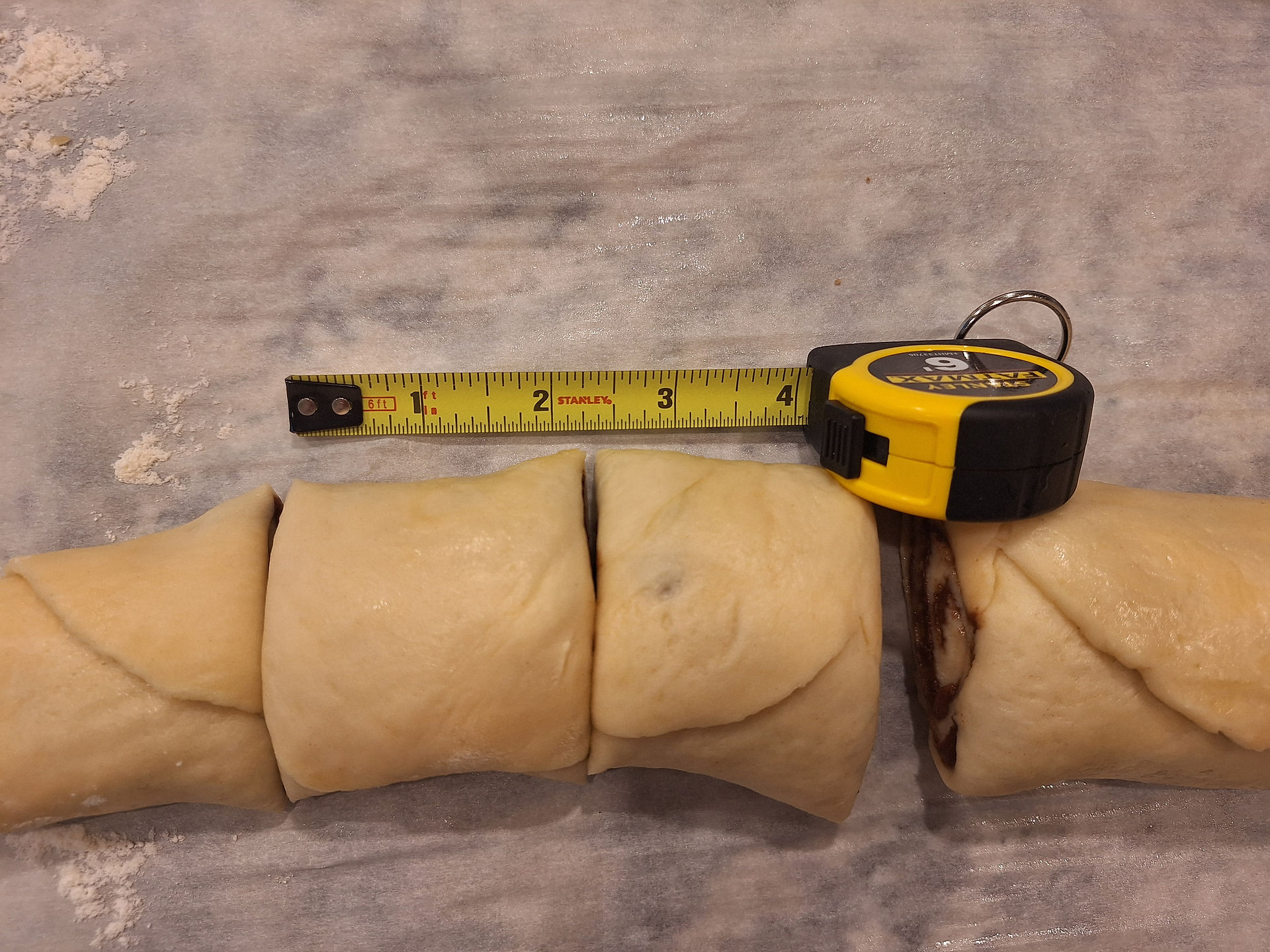 a log of rolled dough cut into pieces of about 2 inches