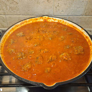 Gently place the browned meatballs into the sauce. Simmer uncovered on low for 25–30 minutes, turning them halfway through. Stir in 1 tablespoon of butter before serving for extra richness. Optional: add 1 tablespoon Parmesan.