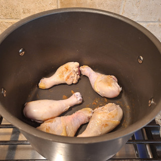 Heat a large pot over medium-high heat. Place the chicken drumsticks directly into the dry pot and sear them on all sides until lightly golden.