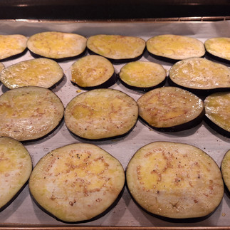 Brush the eggplant and potato slices with olive oil, and season with salt and pepper. - Arrange them in a single layer on baking sheets and roast in the preheated oven until tender and lightly browned, about 20 minutes. Set aside.