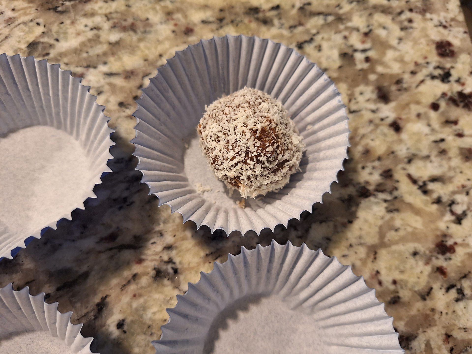 Shape into pingpong-sized balls using your hands (about 20 total).  Roll each ball in desiccated coconut or sprinkles.