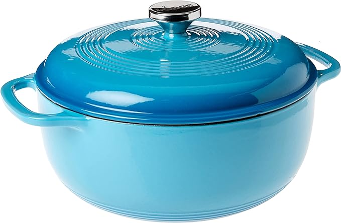 Blue cast iron Dutch oven with shiny finish and circular ridges on the lid, featuring a small handle. Minimalist white background.