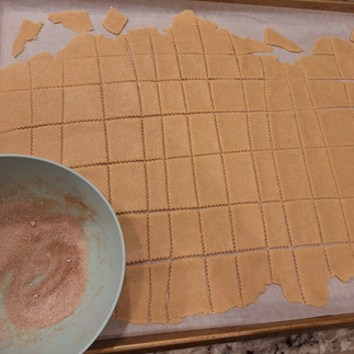 Remove the top parchment paper. Use a knife, pizza cutter, or cookie cutter to create squares, rectangles, or your desired shapes. Leave them on the parchment for easy transfer.